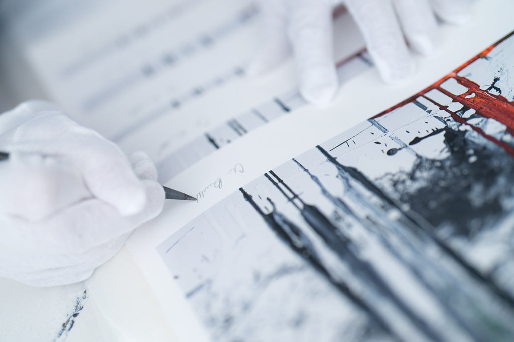 Chris hand signing individual limited release prints