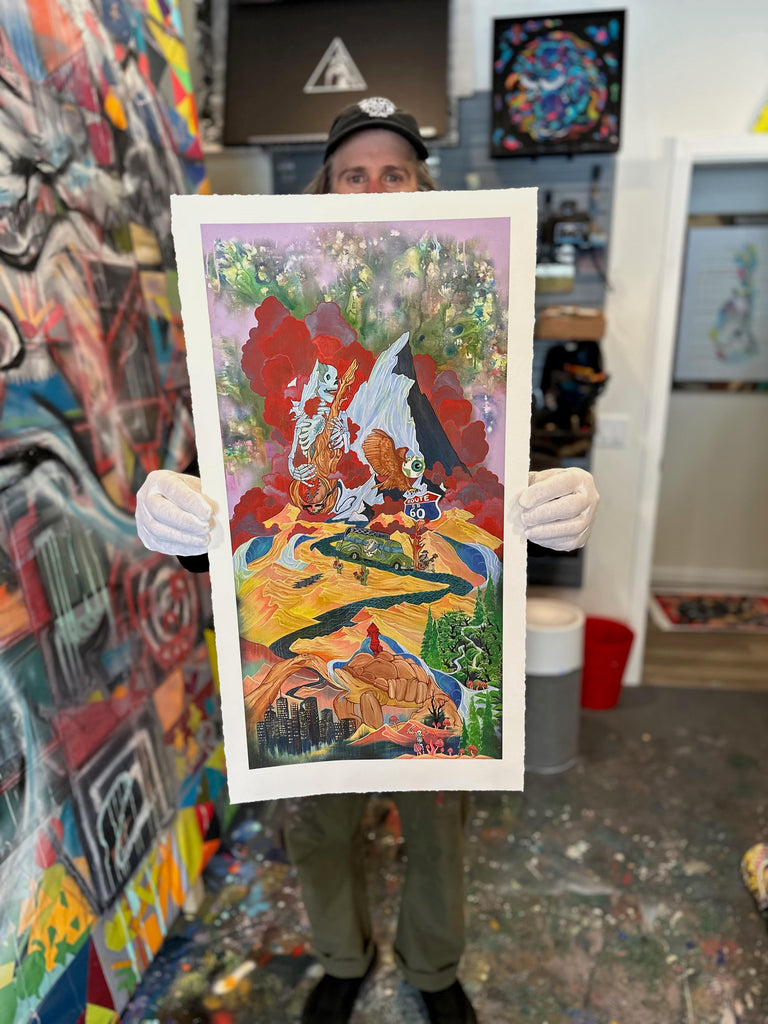 Chris in his studio holding up his Ripple In Time limited release print